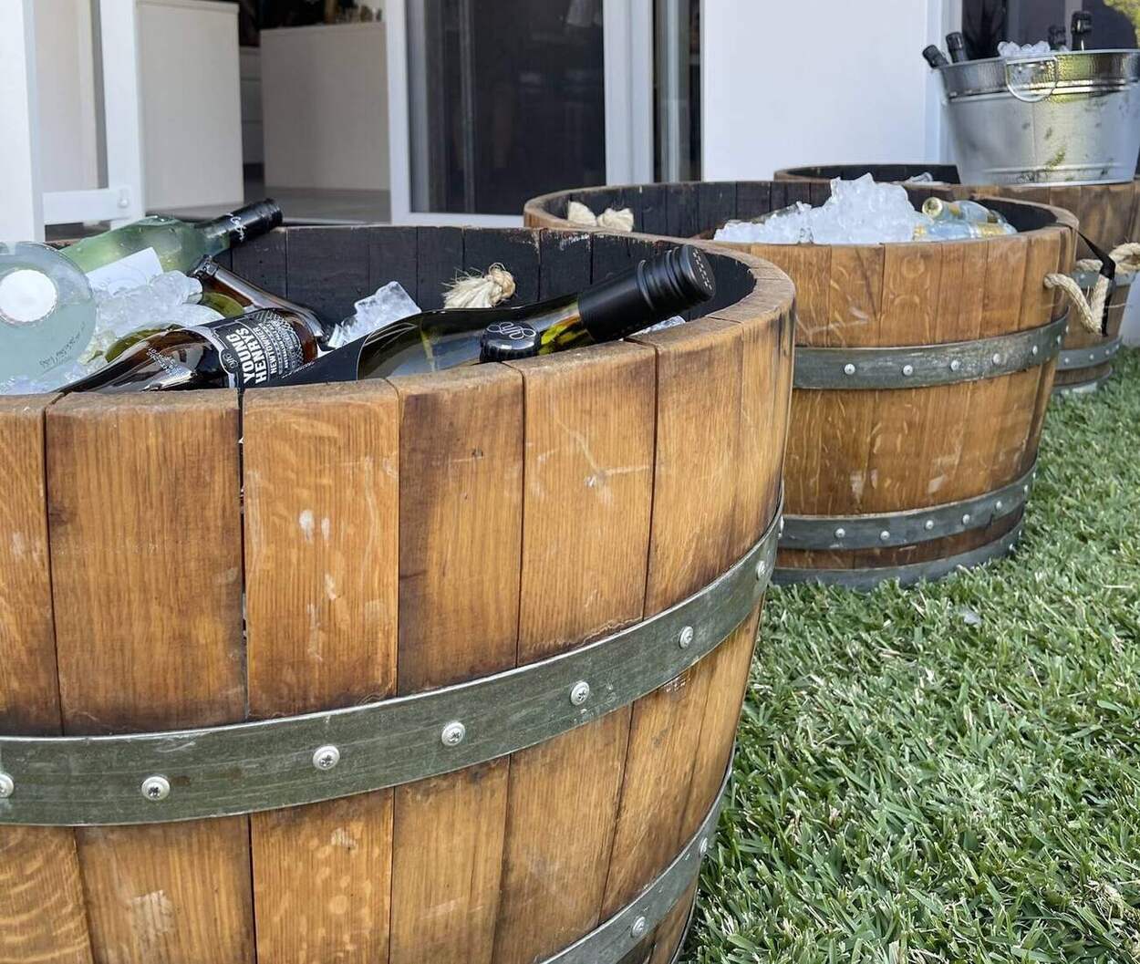 Half wine barrels used as drink and ice tubs at an outdoor event